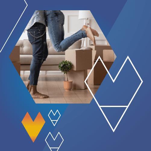 Two people wearing jeans stand inside a room with cardboard boxes. One person is being lifted, their legs bent. The scene is framed in a hexagon with geometric heart shapes on a blue background.