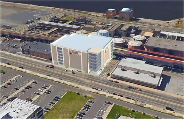 Aerial view of proposed Energizer building with surrounding parking and river backdrop, featuring industrial and commercial structures nearby.
