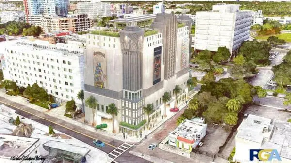Aerial view of a multi-story building with art deco design, surrounded by trees, cars, and other buildings in an urban area.