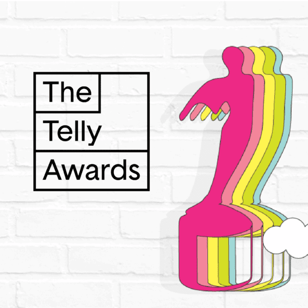 Telly Awards logo next to a colorful, abstract silhouette of a winged figure against a white brick background.