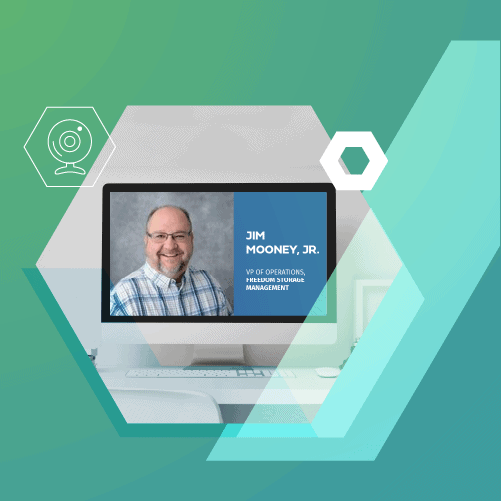 A portrait of a smiling man on a digital screen with the text, "Jim Mooney Jr., VP of Operations Premium Solutions Management," set against a graphic background with geometric shapes.