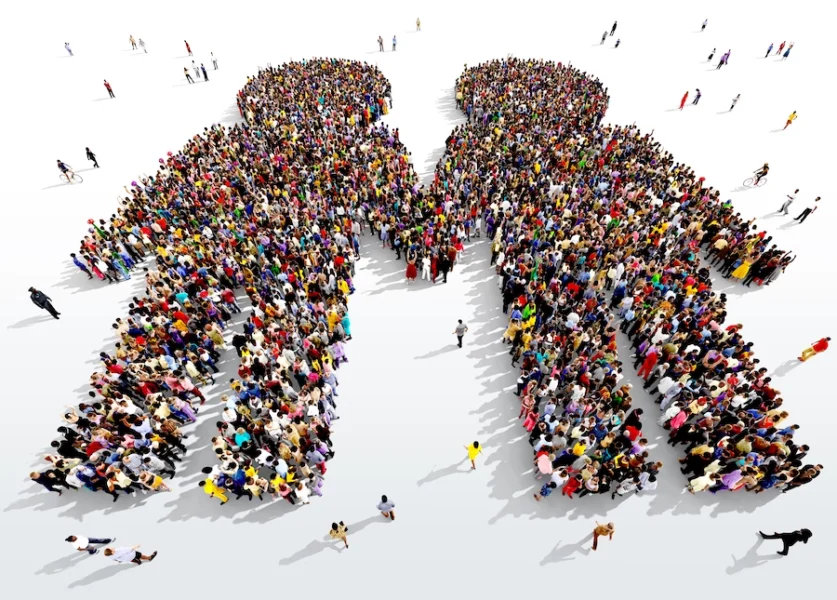 Large crowd forming the shape of two human figures, viewed from above on a white background.