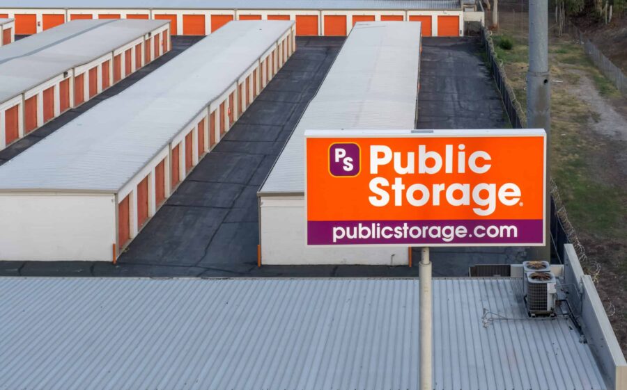 Public Storage facility with rows of storage units and a prominent sign displaying the logo and website.
