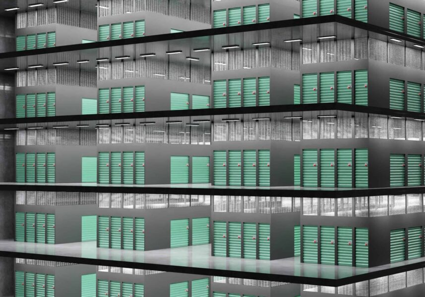 A multi-story building facade featuring numerous rows of teal-colored balcony doors, arranged in a repetitive geometric pattern.